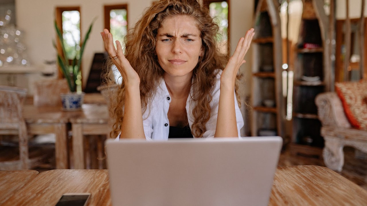 Woman showing frustration with laptop